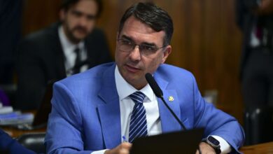 Aliados do pré-candidato do PL à Presidência da República, Flávio Bolsonaro, avaliam adiar em cerca de três meses o lançamento de seu plano de governo.nA promessa era divulgar os pontos principais de um programa no fim de março. No entanto, com a alta de Flávio nas pesquisas, interlocutores do senador defendem jogar o lançamento apenas para junho.nA estratégia avaliada, segundo relatos feitos à CNN, tem como objetivo não contaminar essa "boa fase" -- que culminou com empate nas simulações contra o presidente Luiz Inácio Lula da Silva (PT) -- com um noticiário potencialmente negativo.nnIsso porque parte das propostas, em um aceno para o mercado, envolve questões impopulares como novas reformas macroeconômicas e uma remodelação do arcabouço fiscal.nAliados de Flávio afirmam que, embora sejam propostas necessárias, elas abrem o flanco para críticas e para uma agenda de desgaste eleitoral. Por isso, preferem postergar a divulgação de um plano.nA pré-campanha tem dialogado e se aconselhado com vários expoentes econômicos da gestão Jair Bolsonaro (PL), como o próprio ex-ministro Paulo Guedes, Roberto Campos Neto (ex-presidente do Banco Central), Adolfo Sachsida (ex-secretário de Política Econômica) e Gustavo Montezano (ex-presidente do BNDES).nA economista Daniela Marques, braço direito de Guedes no antigo Ministério da Economia e ex-presidente da Caixa, também tem sido consultada e é um dos nomes potenciais para assumir a área econômica em um eventual governo Flávio Bolsonaro a partir de 2027.nUm interlocutor próximo do pré-candidato bolsonarista, contudo, afirma que não há favoritos neste momento e define o que vai ser decisivo para a escolha de um "superministro" da Fazenda no futuro: o "match", a boa química, em conversas com o próprio Flávio.nhttps://www.youtube.com/watch?v=XsBLQXqoqBk